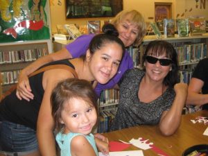 Family of four women posing at storytime