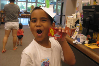 Justin holding his coveted library card.