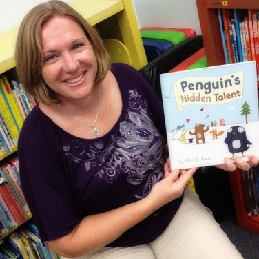 Woman holding a book called 'Penguins hidden talent'