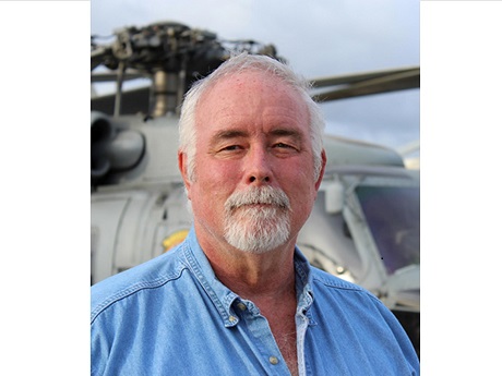 Burl Burlingame in front of a helicopter