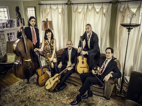 Group of 5 musicians posing with their instruments.