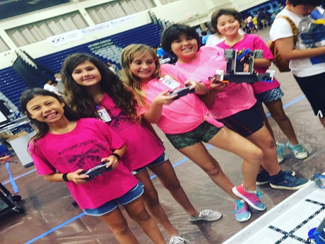 Huakailani Robotics Team picture holding controllers and robots