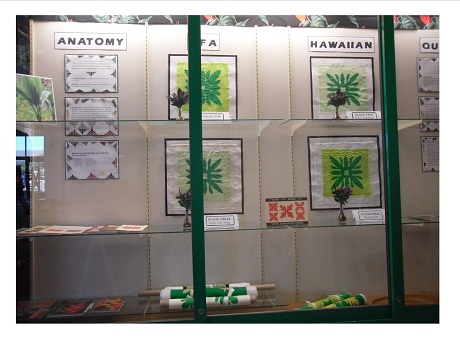 Photo of pieces of Hawaiian quilt at various stage of completion in Kapolei Public Library 1st-floor display case