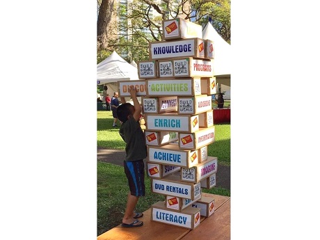 Child playing Giant Jenga