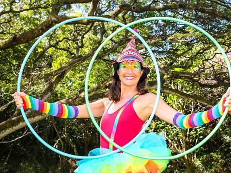 female clown holding two hula hoops