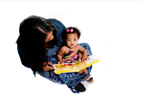 Mom reading book to baby