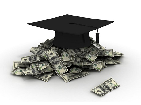 Black mortarboard atop pile of money