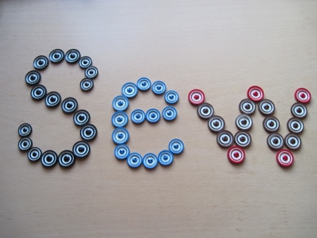 Buttons laid out to spell the word 'SEW'