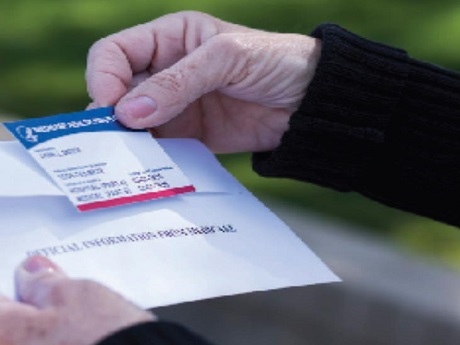 Woman holding Medicare ID card in her hands