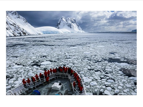 Ship the National Geographic Explorer sailing the ice-strewn Southern Ocean with scientists on her deck