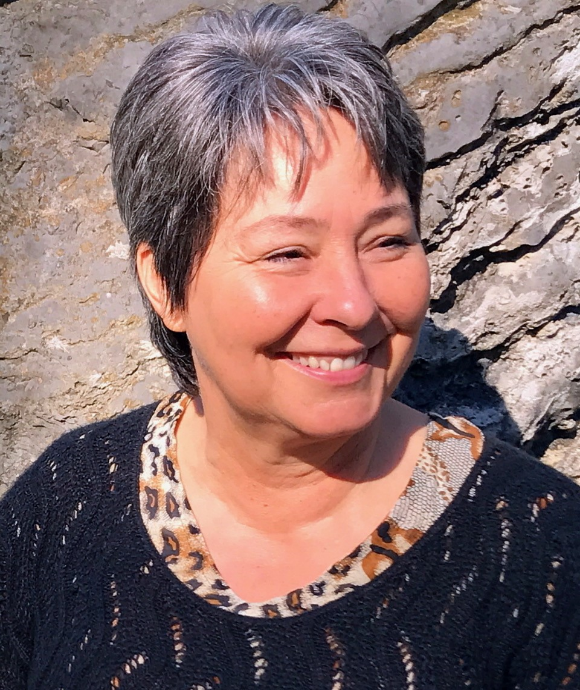 Shira headshot in front of a rock wall