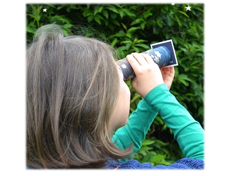 Child looking through telescope