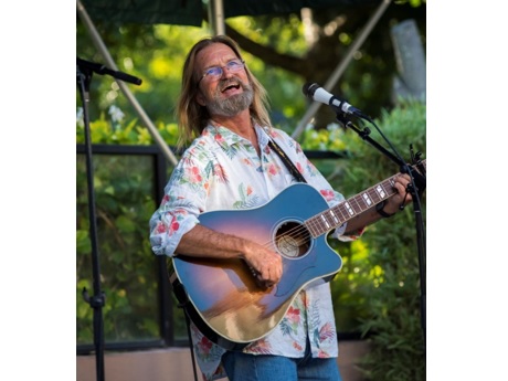 Uncle Wayne Watkins playing a guitar