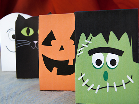 Halloween bags crafted into Frankenstein, jack-o-lantern, cat, and ghost faces