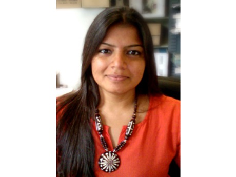 a woman in a red shirt looking at the camera