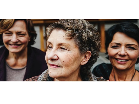 Image of 3 women with one in the foreground looking off to her right