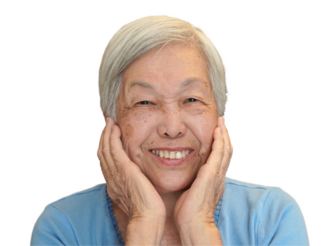 Hawaii's Pickle Lady, smiling at the camera with her hands cupping her face