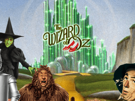 Text: "The Wizard of Oz," with the ruby slippers in the "O," superimposed over the Emerald City, with the Witch, the Cowardly Lion, and the Scarecrow in the foreground.