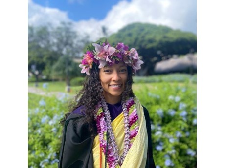 Smiling woman in leipoʻo, lei and kihei