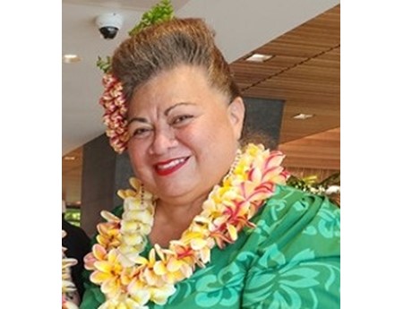 Hawaiian woman with lei and green dress