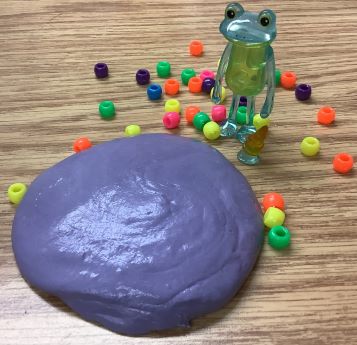 Purple slime with blue-green translucent frog and colored beads