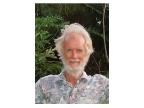 Headshot of older man with white hair in an aloha shirt