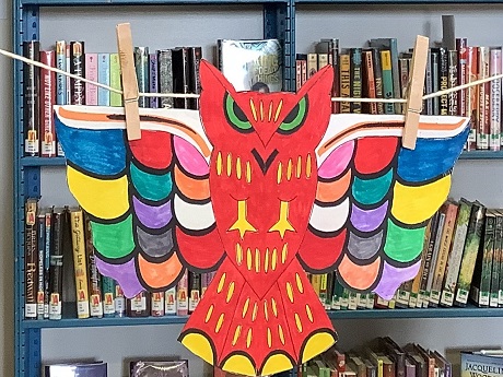 a red paper owl with colorful wings